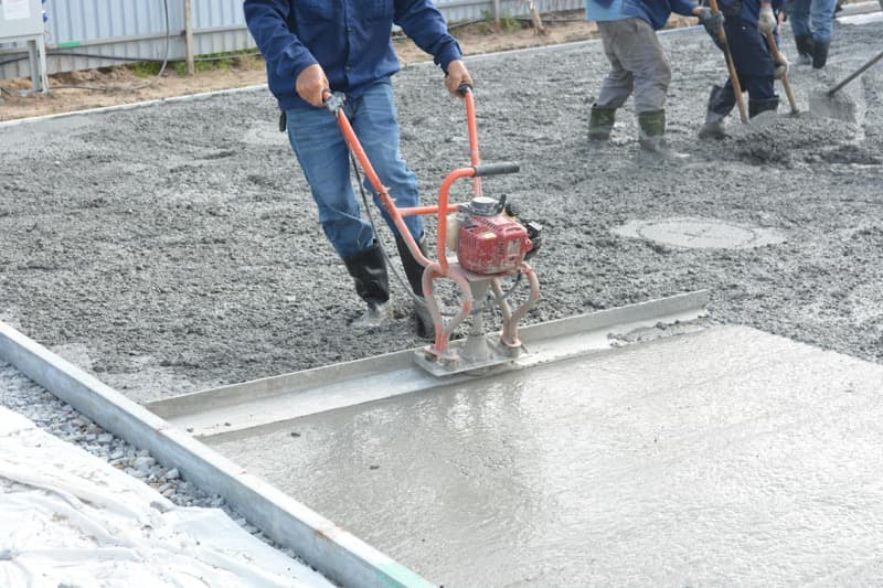 freshly poured concrete driveway with expansion joints and smooth finish