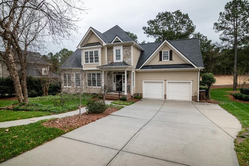 side-by-side concrete driveway versus asphalt driveway comparison
