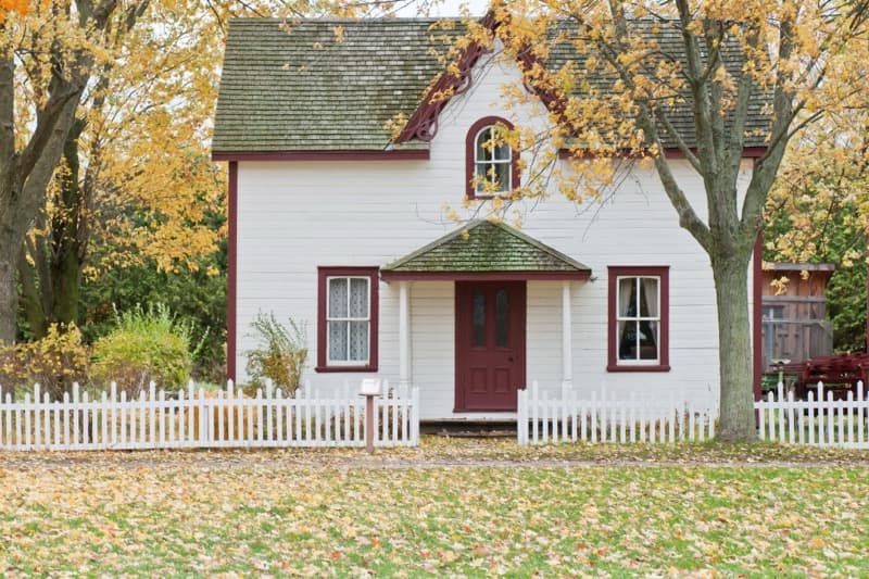 wood fence versus vinyl fence comparison showing maintenance differences