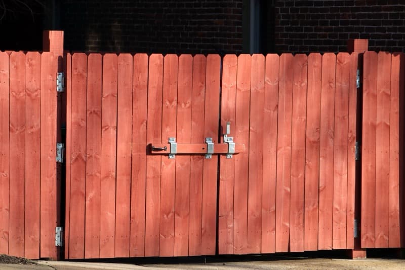side-by-side comparison of wood, vinyl, and aluminum fence types