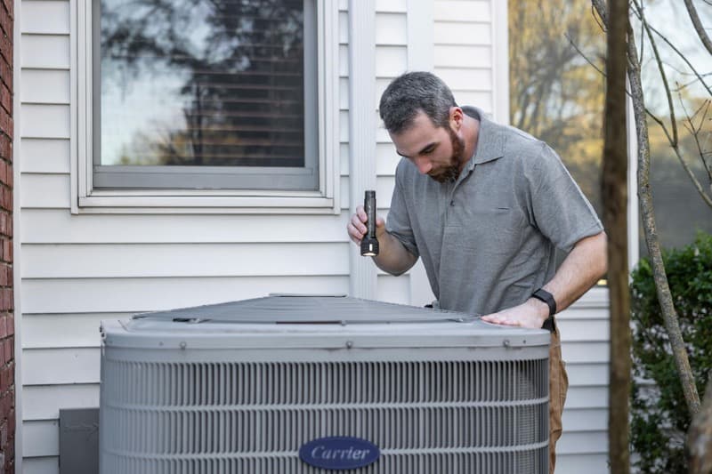 homeowner reviewing HVAC warranty and insurance documents
