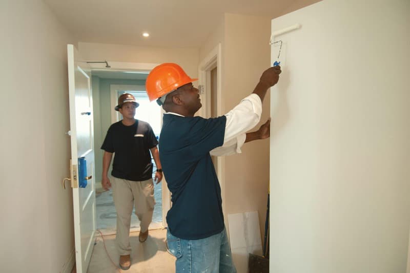 homeowner painting a room versus professional painter comparison