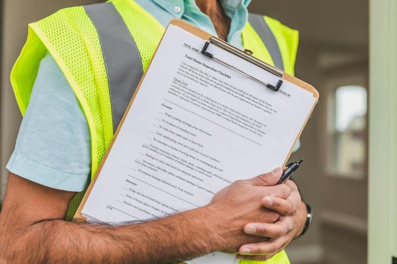 homeowner reviewing pest control contract with licensed exterminator