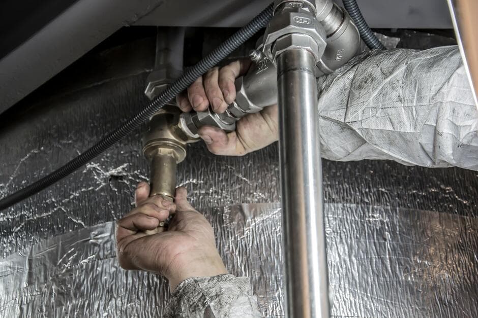 plumber installing a tankless water heater